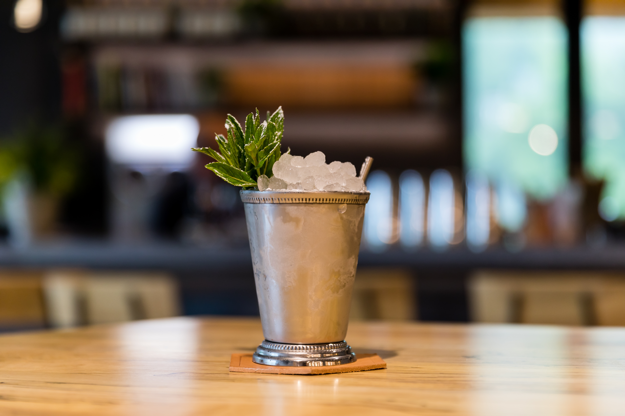 mint julep with gin - cocktail in a metal julep cup with fresh mint garnish
