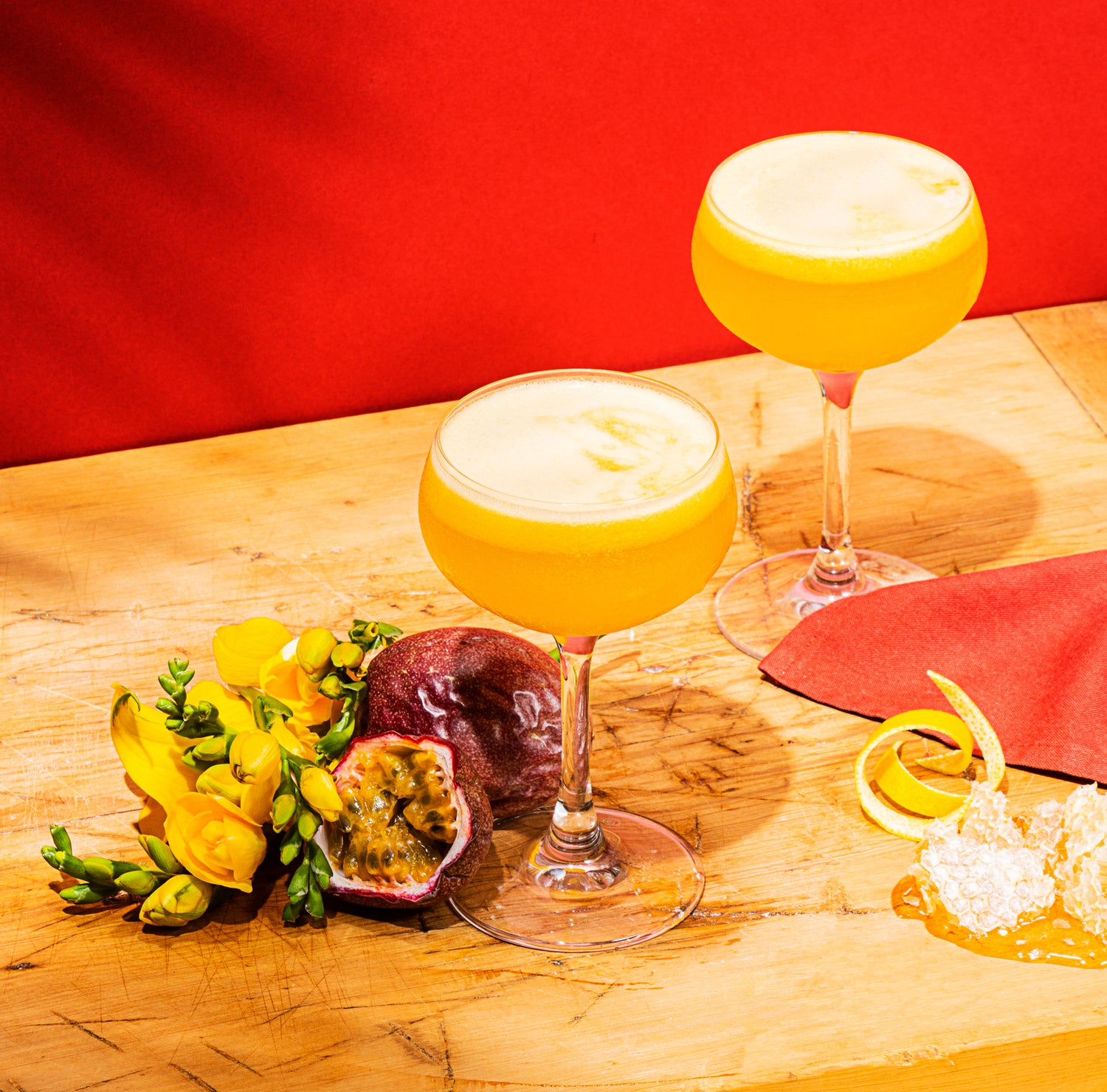 Passionate Bees Knees Cocktail by Barr Hill Gin, A tropical, fruity drink made with gin, passionfruit syrup, lemon, and honey.